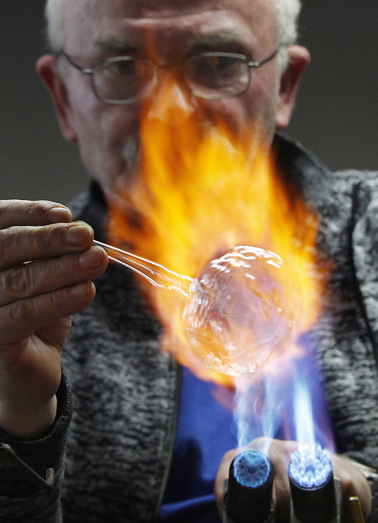 Shaping hot glass into decoration